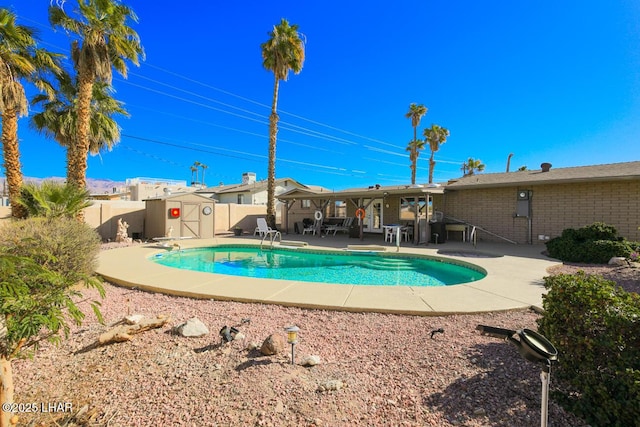 view of pool featuring a storage unit and a patio