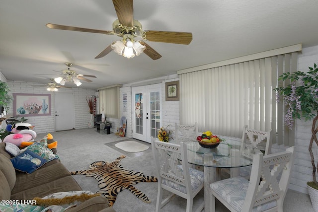 living room featuring french doors, brick wall, and carpet flooring