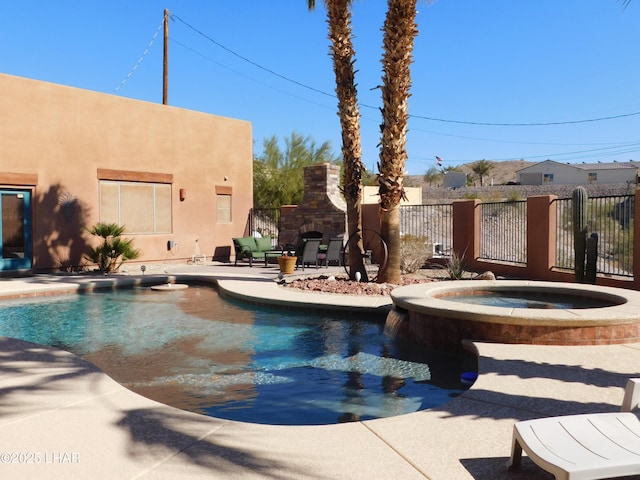 view of pool featuring an in ground hot tub, a patio area, and an outdoor stone fireplace