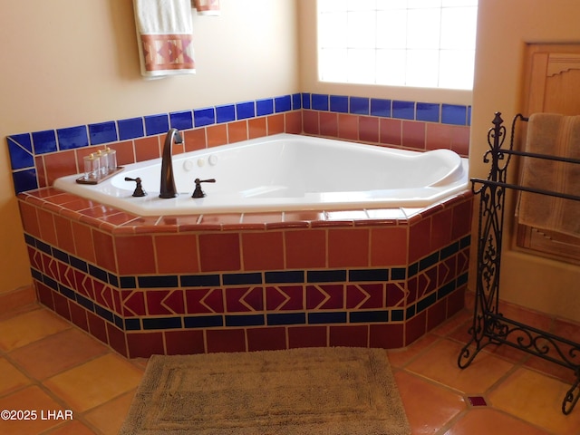 bathroom featuring tile patterned flooring and tiled tub