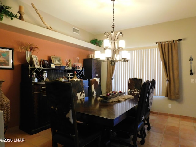 dining area with an inviting chandelier