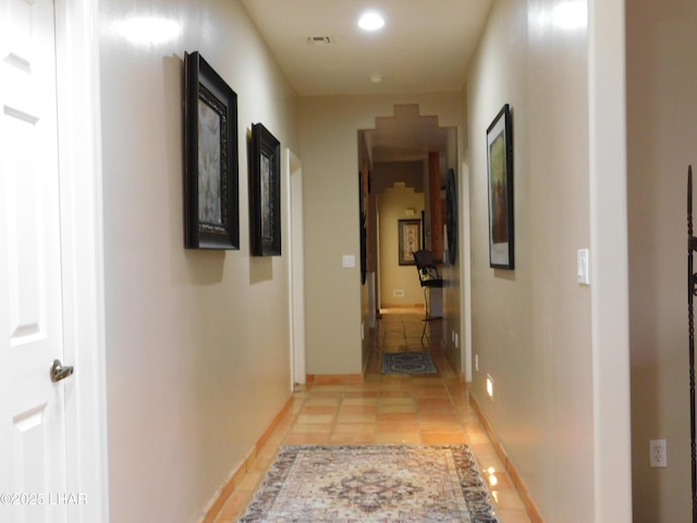 hall featuring light tile patterned floors