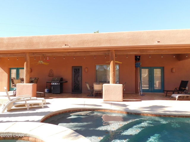 rear view of property featuring a patio, french doors, and ceiling fan