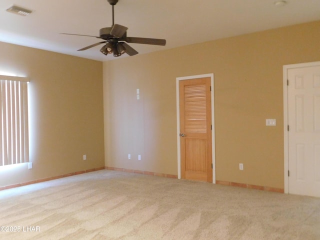 carpeted spare room with ceiling fan