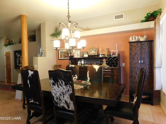 tiled dining room with an inviting chandelier