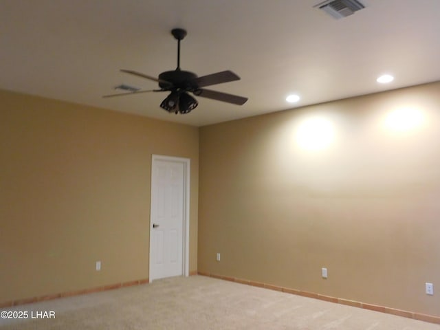 carpeted empty room featuring ceiling fan