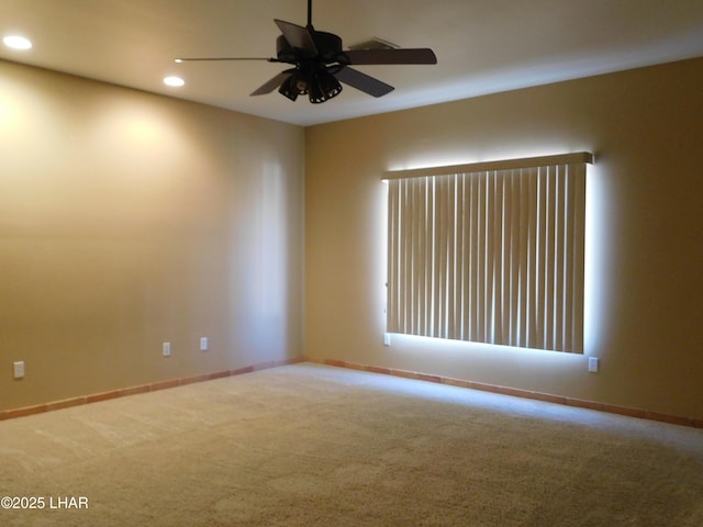 empty room featuring ceiling fan and carpet flooring