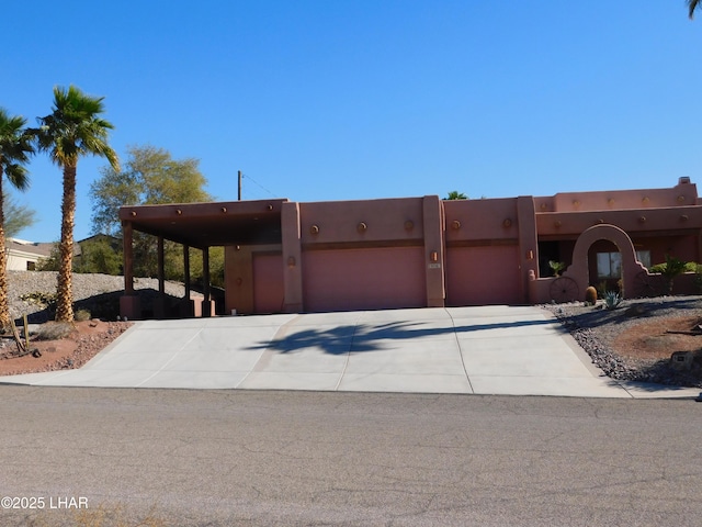 pueblo revival-style home with a garage