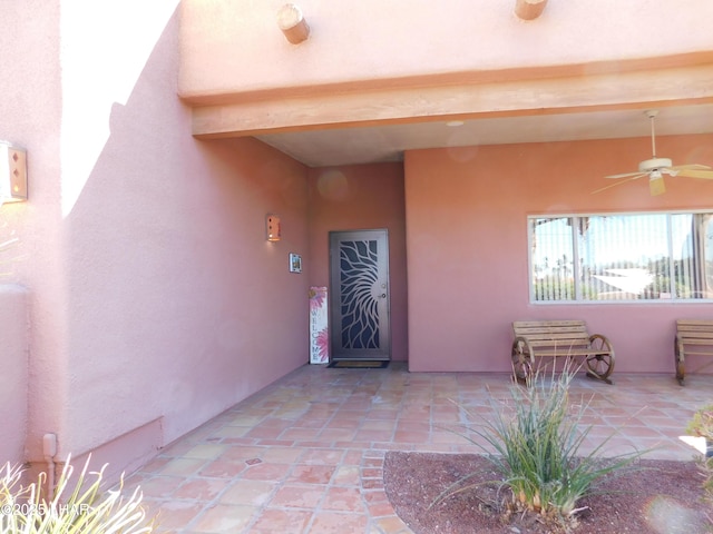 property entrance featuring ceiling fan and a patio area