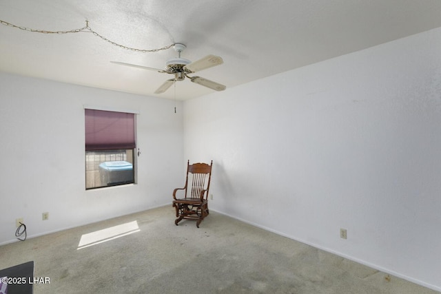 unfurnished room with carpet flooring and a ceiling fan