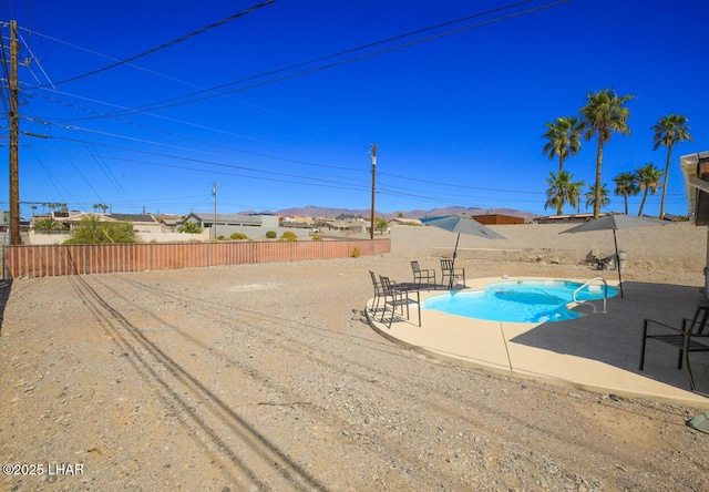 view of pool featuring a fenced in pool, a fenced backyard, and a patio area