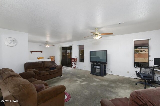 living area with carpet floors, a textured ceiling, and ceiling fan