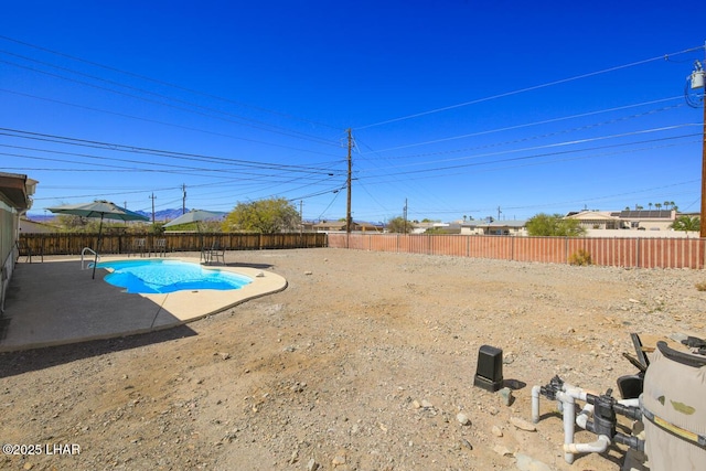 view of yard featuring a patio area, a fenced in pool, and a fenced backyard