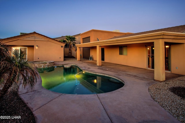 view of pool featuring a pool with connected hot tub and a patio area