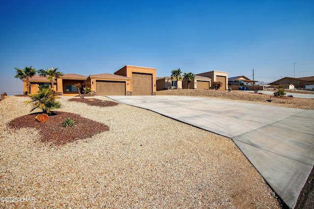 view of front of home with an attached garage, driveway, and stucco siding