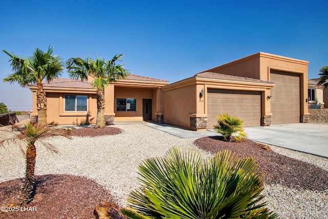 view of front of home featuring an attached garage, stone siding, concrete driveway, and stucco siding