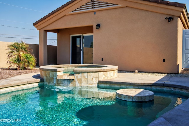 view of swimming pool featuring a pool with connected hot tub and fence