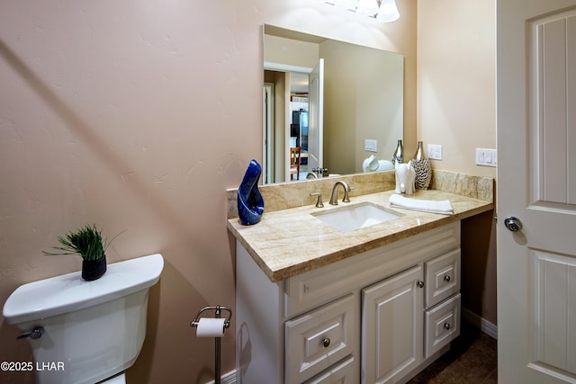 bathroom featuring vanity and toilet