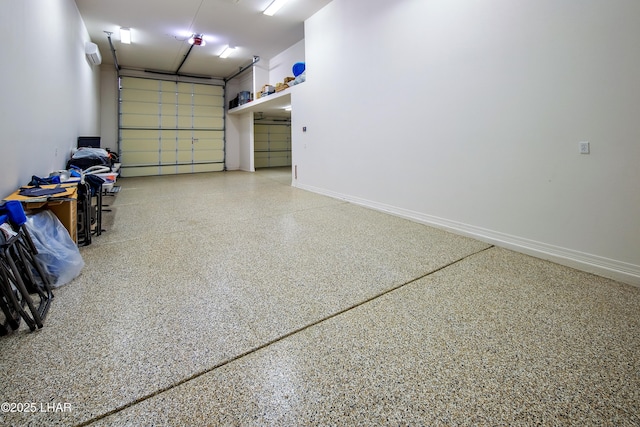 garage with a wall mounted air conditioner and baseboards