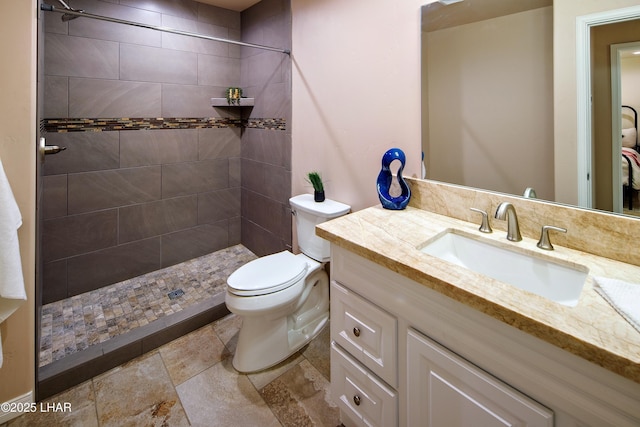 full bathroom with vanity, toilet, and a shower stall