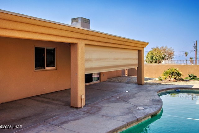 view of patio / terrace with a fenced in pool and fence