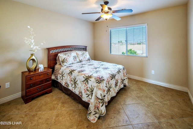 bedroom with ceiling fan, baseboards, and light tile patterned flooring