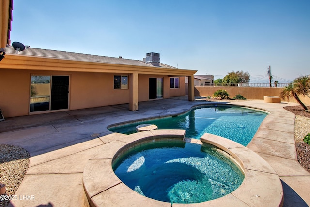 view of swimming pool featuring central AC, a patio, a fenced backyard, and a pool with connected hot tub