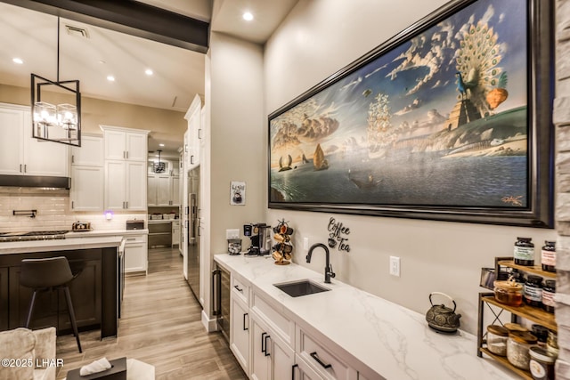 interior space featuring sink, hardwood / wood-style floors, and backsplash