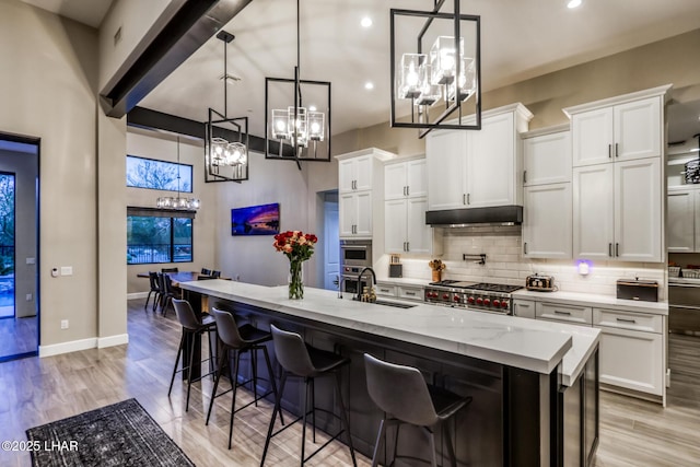 kitchen with hanging light fixtures and white cabinets