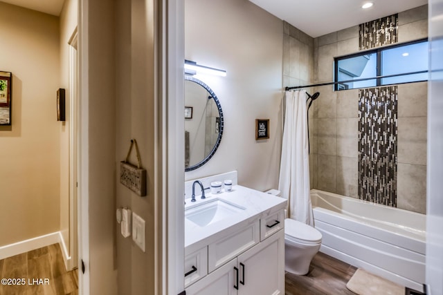 full bathroom featuring wood-type flooring, toilet, shower / bath combination with curtain, and vanity