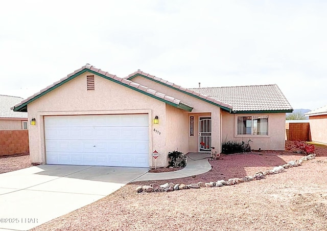 ranch-style house featuring stucco siding, driveway, fence, a garage, and a tiled roof