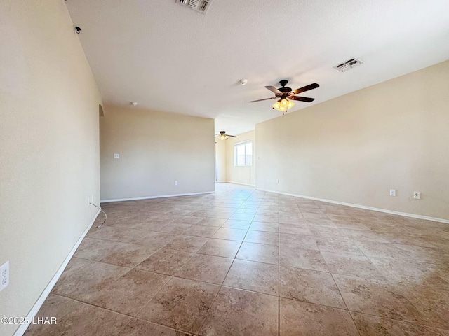 unfurnished room with visible vents, baseboards, and ceiling fan