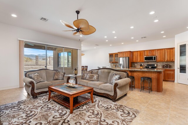 living room with light tile patterned floors and ceiling fan