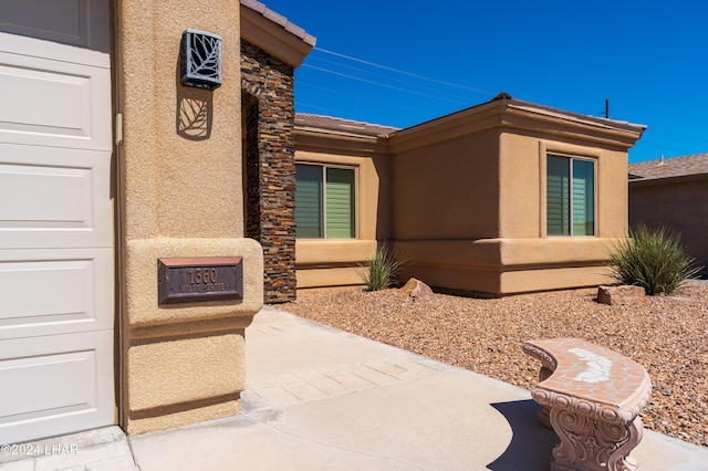 view of exterior entry featuring a patio