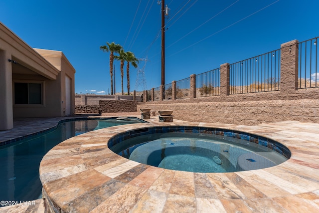 view of swimming pool with an in ground hot tub