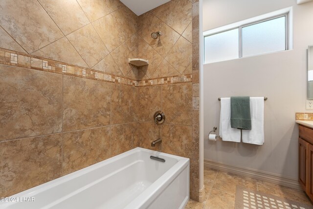 bathroom with vanity and tiled shower / bath