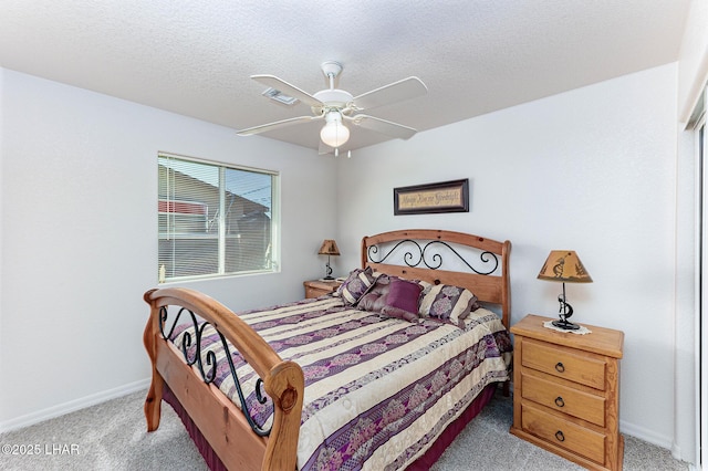 carpeted bedroom featuring ceiling fan and a textured ceiling