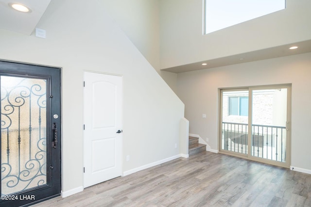 entrance foyer with a high ceiling and light wood-type flooring