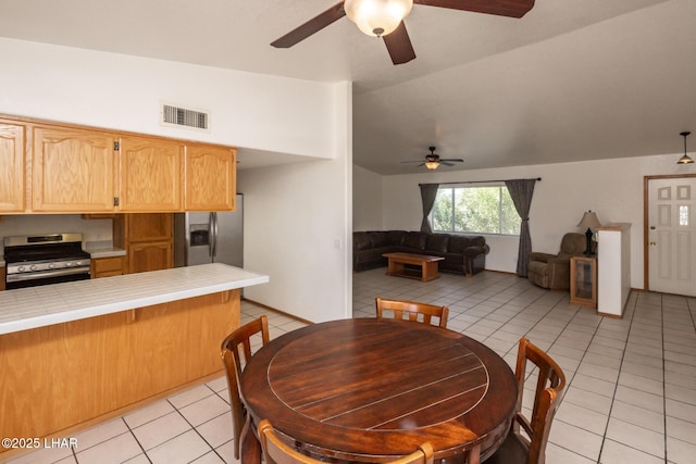 2130 Smoketree Ave N, Lake Havasu City, AZ 86403 - dining area featuring visible vents, lofted ceiling, light tile patterned floors, and a ceiling fan
