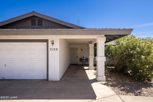 2130 Smoketree Ave N, Lake Havasu City, AZ 86403 - view of front facade featuring stucco siding, a garage, and board and batten siding
