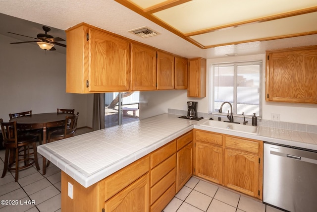 2130 Smoketree Ave N, Lake Havasu City, AZ 86403 - kitchen featuring light tile patterned flooring, visible vents, dishwasher, ceiling fan, and a sink