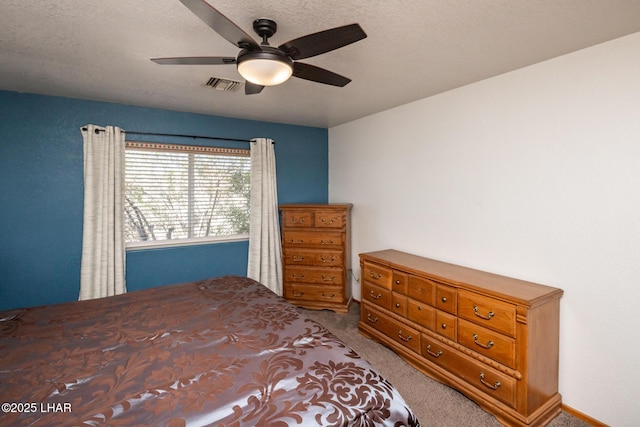 2130 Smoketree Ave N, Lake Havasu City, AZ 86403 - carpeted bedroom with visible vents, a ceiling fan, and a textured ceiling