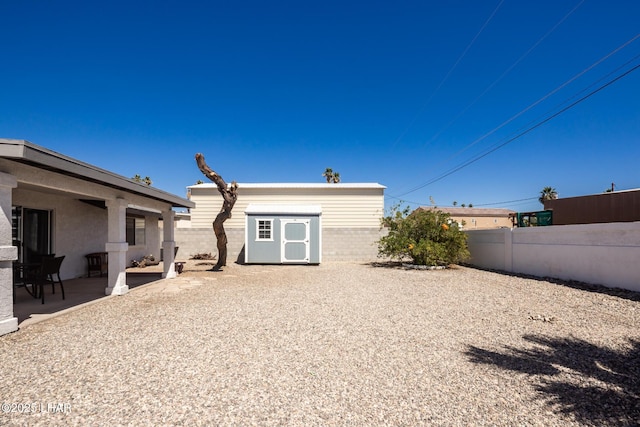 2130 Smoketree Ave N, Lake Havasu City, AZ 86403 - back of house featuring fence, a shed, an outdoor structure, and a patio