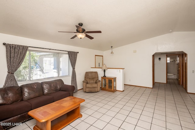 2130 Smoketree Ave N, Lake Havasu City, AZ 86403 - living area featuring lofted ceiling, light tile patterned floors, baseboards, arched walkways, and ceiling fan