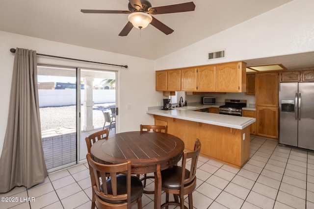2130 Smoketree Ave N, Lake Havasu City, AZ 86403 - kitchen with visible vents, a peninsula, appliances with stainless steel finishes, a sink, and vaulted ceiling