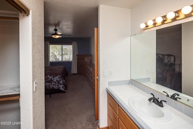 2130 Smoketree Ave N, Lake Havasu City, AZ 86403 - bathroom featuring vanity, connected bathroom, ceiling fan, and a textured ceiling