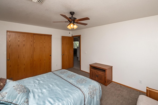 2130 Smoketree Ave N, Lake Havasu City, AZ 86403 - carpeted bedroom with a closet, a ceiling fan, a textured ceiling, baseboards, and visible vents