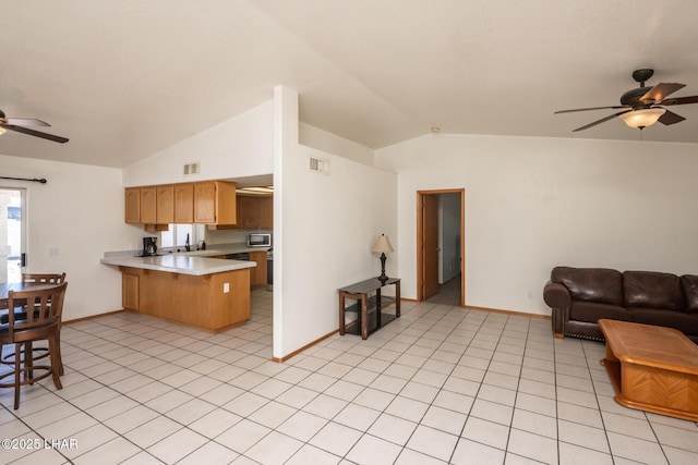 2130 Smoketree Ave N, Lake Havasu City, AZ 86403 - kitchen with light countertops, visible vents, a peninsula, a ceiling fan, and open floor plan