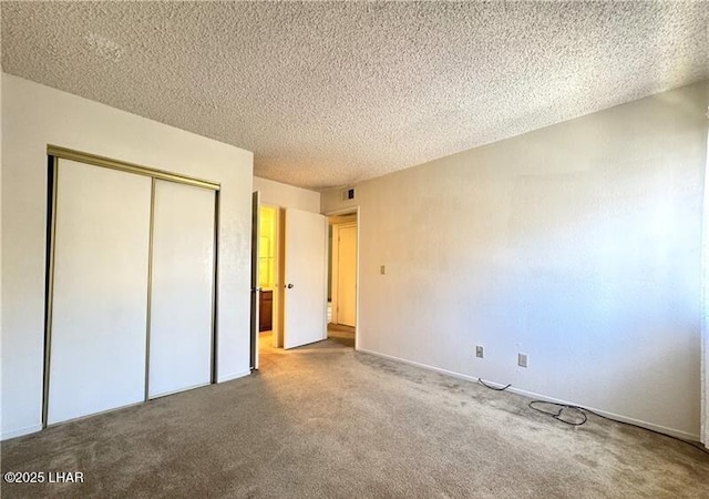 unfurnished bedroom featuring a closet, a textured ceiling, and carpet flooring