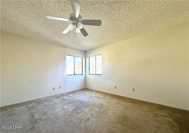 carpeted empty room with ceiling fan and a textured ceiling